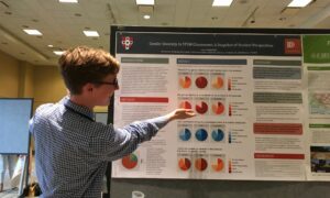 Isaac Klimasmith with poster at New Horizons Conference